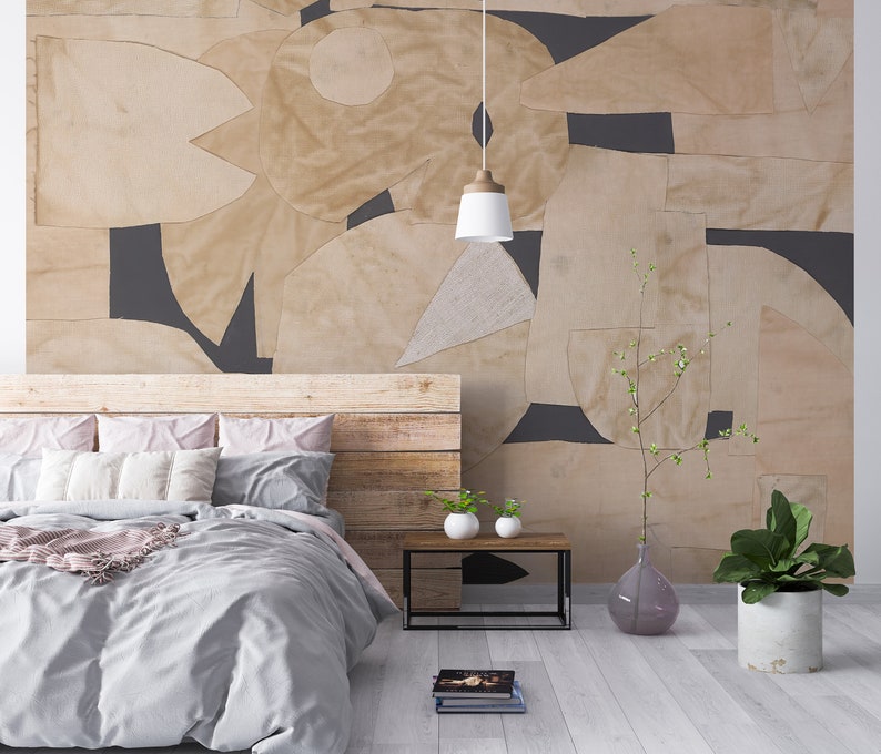Minimalist-inspired wallpaper mural with a collage of beige geometric cutouts over a dark base, providing a sophisticated and removable wall decor option.