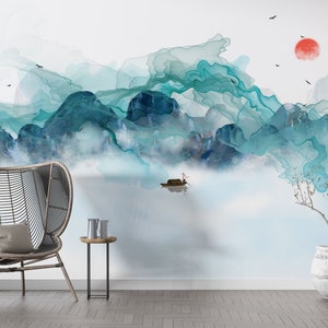May include: A watercolor painting of a mountain landscape with a small boat in the foreground. The mountains are painted in shades of blue and green, and the sky is a light blue. The painting is framed by a white wall and a wooden floor.