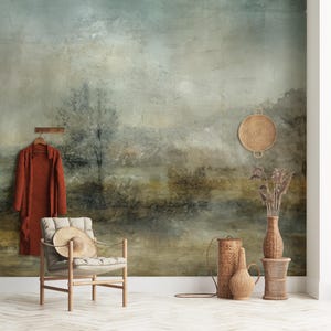 May include: A watercolor-style wall mural depicting a misty landscape with a muted color palette of greens, blues, and browns. The mural features a single tree in the foreground and a hazy background.