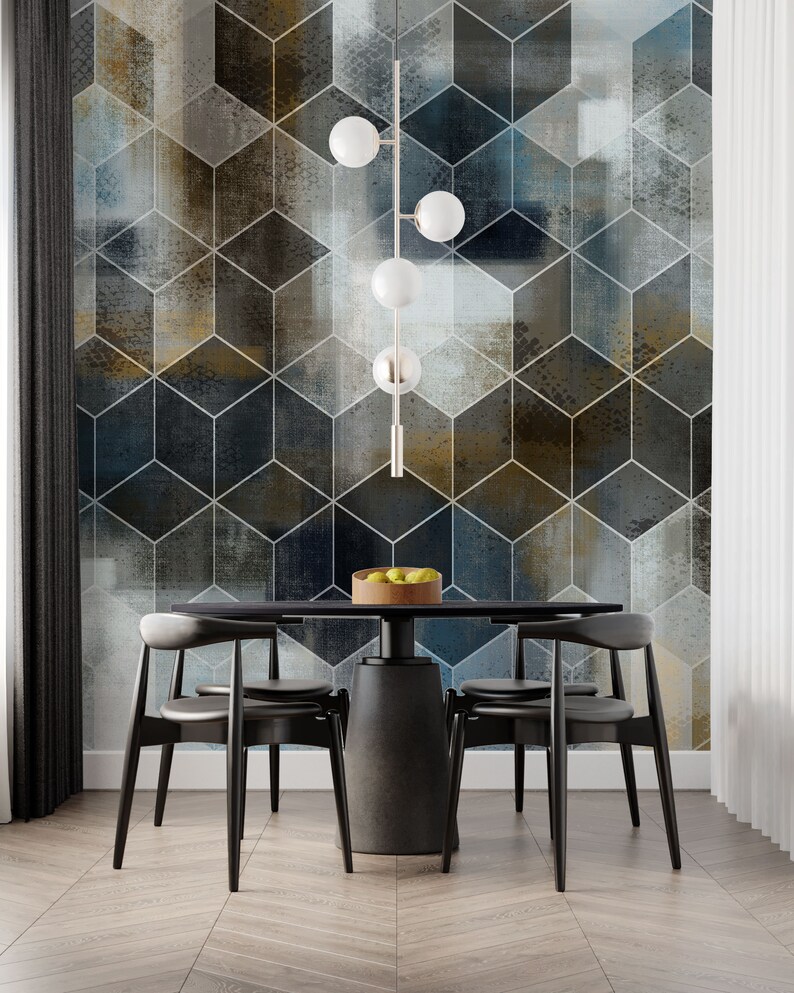 May include: A black dining table with four black chairs and a modern light fixture with five white globe lights hanging above it. The table is set with a bowl of fruit. The wall behind the table is covered in a geometric wallpaper with a blue, gray, and gold color scheme.