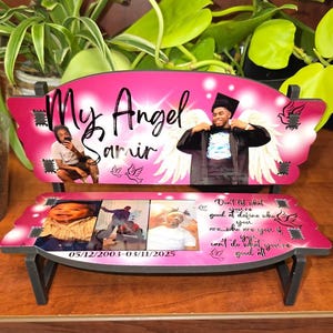 以下が含まれることがあります： 背もたれに若い男性の写真がついたピンク色の木製ベンチ。ベンチには「My Angel Samir」という文字が書かれている。ベンチには、若い男性の子供の頃の写真と、10代の頃の写真も写っている。ベンチには「05/12/2003-03/11/2025」という日付が書かれている。ベンチには、自分が誰であるかを定義することについての引用も書かれている。