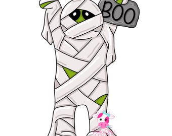 May include: A cartoon mummy character wrapped in white bandages with green skin visible underneath. The mummy has large black eyes and is holding a grey stone sign with the word BOO written in black capital letters above its head.