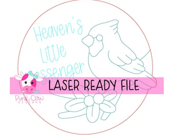 May include: A circular digital graphic featuring a line art cardinal bird perched on a branch with berries. The text reads Heaven's Little Messenger and LASER READY FILE. A small pink cow logo with the text Pink Cow Designs is in the corner.