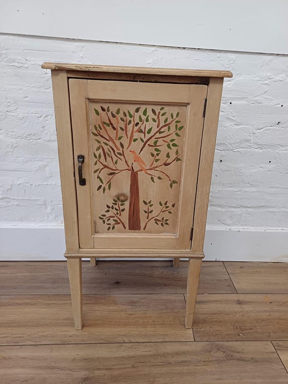 Vintage bedside table with painted bird motif
