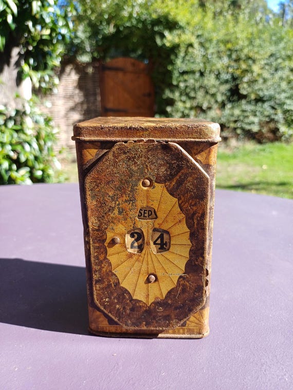 Vintage tin with perpetual calendar