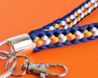 Llavero de Denver: pulsera o cordón con los colores del equipo de los Broncos, cierre de mosquetón plateado.