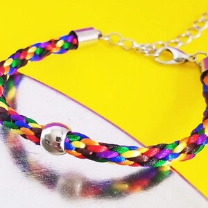 Pride Month Bracelet, LGBTQ Pride diversity flag colors, hand-braided satin thread with a round silver accent bead and adjustable clasp.