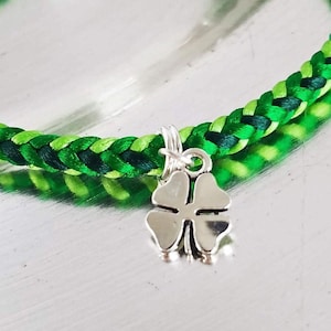 St. Patrick&#39;s Day bracelet, lucky clover bracelet, satin thread in green color mix with a silver lucky four-leaf clover charm and hook clasp