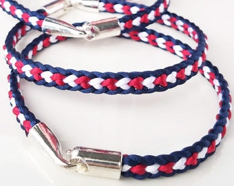 USA Patriotic Bracelet in American flag colors: Hand-woven flat braid satin thread in red white and blue colors with a silver accent clasp.