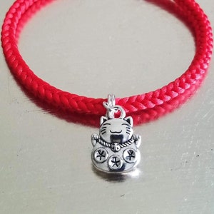 Chinese Bracelet with Lucky Tiger Charm: Hand-woven satin thread square braid in red with antique silver lucky cat charm & silver hook clasp