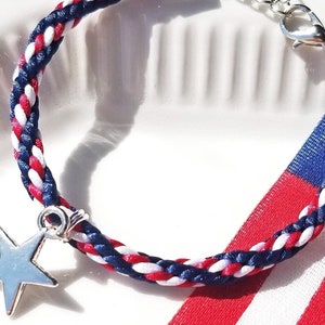 4th of July Bracelet in American Flag colors: hand-braided satin thread in red white and blue with a silver star charm and adjustable clasp.