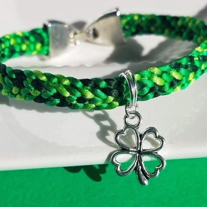 St Patrick&#39;s Day lucky clover bracelet, hand-woven satin flat braid in green color mix, silver 4-leaf clover charm, snap-clip clasp, 7 sizes