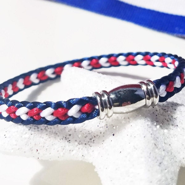USA 4th of July Independence Day Bracelet: Hand-woven flat braid satin thread in red white and blue color with a silver-plated accent clasp.