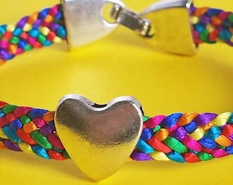 Pride Partner bracelet in an LGBTQ Pride flag color mix, hand-woven satin flat braid with a silver heart bead and snap-clip clasp, 7 sizes!