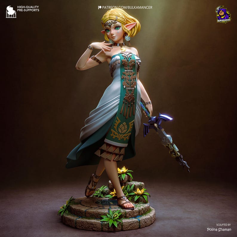 May include: A detailed figurine of a character from The Legend of Zelda. The figure is blonde with pointed ears, wearing a white and teal dress with gold accents, and holding a glowing blue sword. The figure stands on a stone base with flowers.