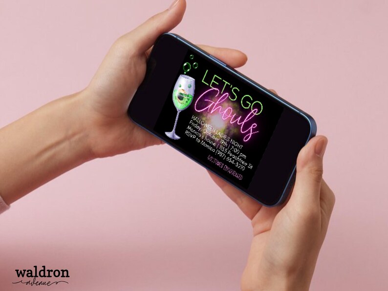 May include: A digital invitation for a Halloween party with the text "Let's Go Ghouls" in neon green and pink lettering. The invitation features a green cocktail with a spooky face and a black background.
