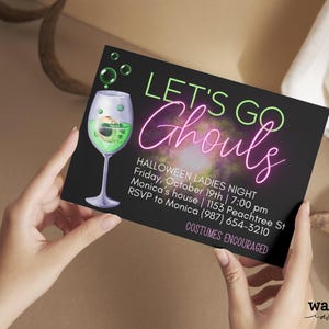 May include: A black invitation card with neon green and pink text that reads "Let's Go Ghouls" with a green cocktail glass with a skull inside. The text below reads "Halloween Ladies Night, Friday, October 19th | 7:00 pm, Monica's house | 1153 Peachtree St, RSVP to Monica (987) 654-3210, Costumes Encouraged".