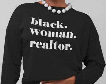 May include: Black woman realtor sweatshirt with white text on a black background. The text reads "black. woman. realtor."