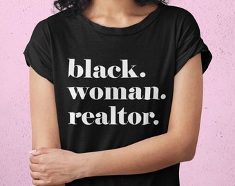 May include: A black t-shirt with the text "black. woman. realtor." printed in white.