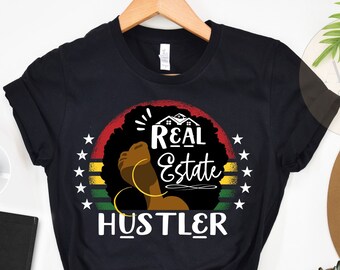 May include: Black t-shirt with a retro-style graphic of a Black woman's silhouette with the text "Real Estate Hustler".