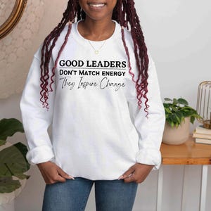 a woman with dreadlocks standing in front of a table