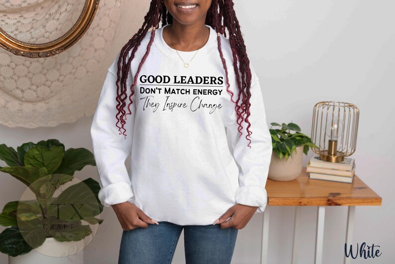 a woman with dreadlocks standing in front of a table