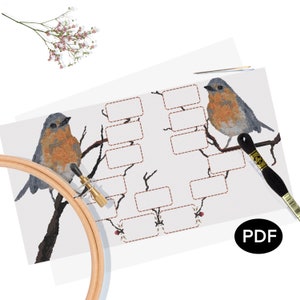 May include: A cross-stitch pattern featuring two bluebirds perched on branches with blank spaces for names. The pattern is printed on white paper with a brown border and the word "PDF" in a circle.