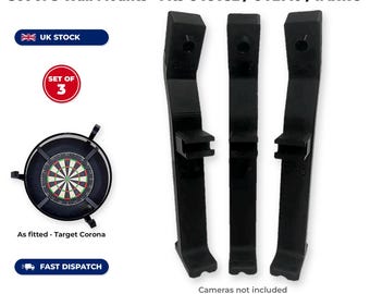 May include: A set of three black 3D printed Autodarts camera arms for Target Corona, compatible with OV9732, OV2710, and IMX179 models. The set includes ring adapters and screws, designed to mount cameras around a dartboard.