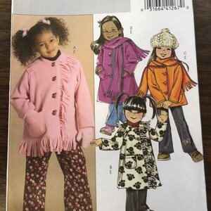 May include: A sewing pattern for children's coats. The pattern includes four different styles: a pink coat with fringe, a purple coat with a scarf, an orange coat with a white hat, and a white coat with black paw prints. The pattern is for sizes 2-3-4-5. The pattern number is B4909/CDD.