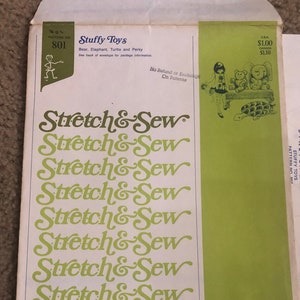 May include: A vintage sewing pattern envelope for making stuffed toys. The pattern is called "Stretch & Sew" and features a green and white color scheme. The envelope shows a drawing of a girl holding a teddy bear, a turtle, and an elephant.