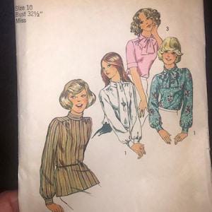 May include: Simplicity sewing pattern number 6625 for a blouse with a 32 1/2 inch bust. The pattern includes four different styles of blouses with a variety of necklines and sleeve lengths.
