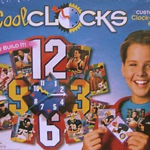 May include: Cool Clocks clock-making kit with a colorful clock face and a variety of trading cards featuring sports themes. You Build It! Customized Clock-Making Kit.