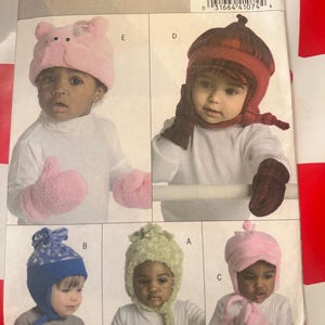 May include: A pattern for children's hats and mittens. The pattern includes various styles, such as a pink pig hat and mittens, a red and brown hat with matching mittens, a blue hat with a star pattern, a green hat, and a pink hat with polka dots.