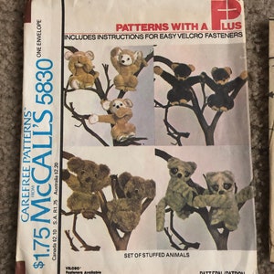 May include: A vintage McCall's sewing pattern envelope for a set of stuffed animals. The pattern is number 5830 and includes instructions for easy Velcro fasteners. The envelope features illustrations of the finished stuffed animals, including monkeys and koalas.