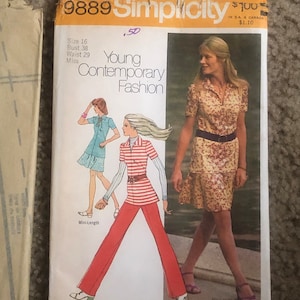 May include: A vintage sewing pattern envelope for a young contemporary fashion design. The envelope is yellow with black text and features a drawing of a woman wearing a floral print dress with a belt. The text on the envelope reads "Simplicity Fashion Magazine" and "9889".
