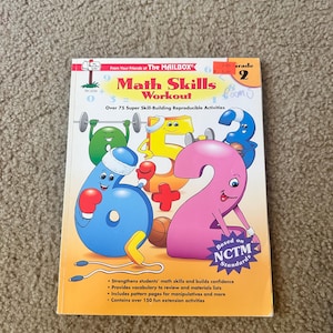 May include: A colorful math workbook titled "Math Skills Workout" for grade 2. The cover features animated numbers and math symbols. The book promises over 75 skill-building activities and is based on NCTM standards.