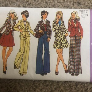 May include: A vintage Simplicity sewing pattern for women's clothing. The pattern number is 5918 and the price is $1.25. The pattern includes five different styles of clothing, including a plaid jacket, a floral skirt, and a pair of bell-bottom pants.