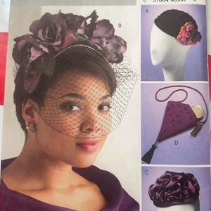 May include: A vintage Butterick sewing pattern, B4695, featuring a woman wearing a headpiece with a veil and a purple jacket. The pattern includes designs for hats and a small purse. The pattern's cover displays the Butterick logo.