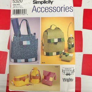 May include: A Simplicity 5320 sewing pattern envelope for accessories by Shirley Botsford Designs. The front displays illustrations of various bags, including a blue patterned tote, a green backpack, a bottle carrier, and small pouches in yellow and pink.