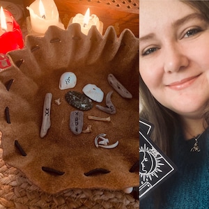 May include: A brown leather pouch with a drawstring closure, filled with various small objects, including bones, stones, and shells. The pouch is sitting on a woven surface.