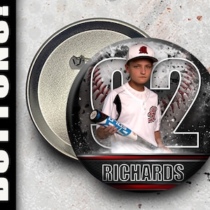 May include: A black and white button with a baseball theme. The button features a young baseball player holding a bat, a baseball, and the number 22. The player is wearing a white jersey with red and black accents. The text "RICHARDS" is printed on the button.