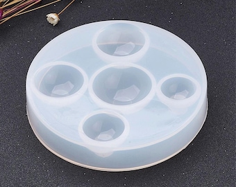 May include: White silicone mold with five round cavities for making resin crafts.
