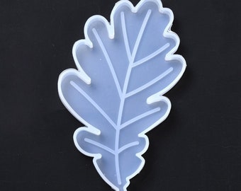 May include: White silicone mold shaped like an oak leaf. The mold is designed for crafting and resin casting.