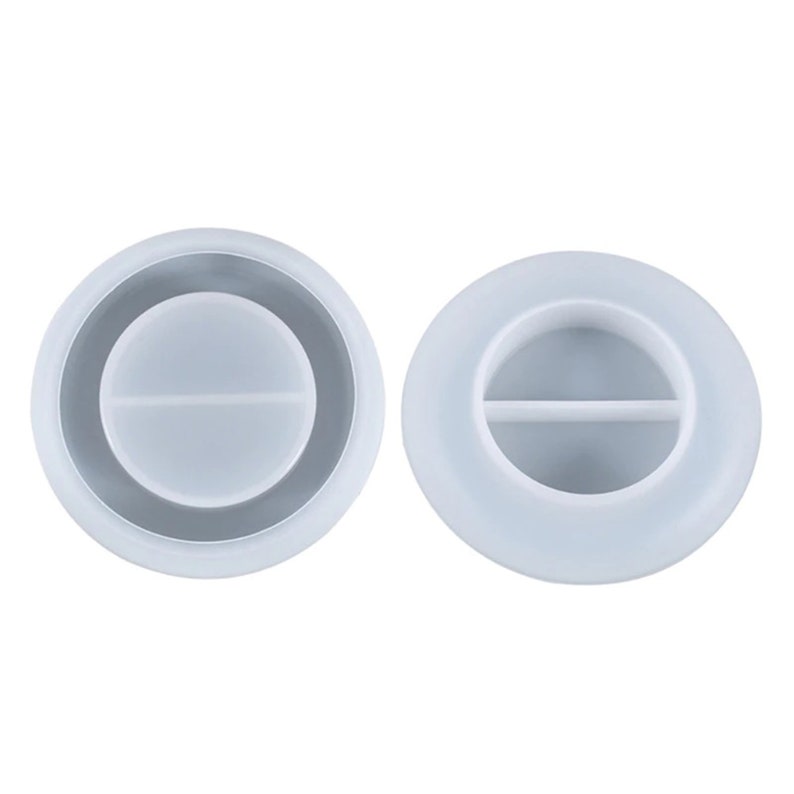 May include: Two clear, circular silicone molds for resin casting. One mold has a dark gray ring around the outer edge. The other mold has a horizontal divider across the center.