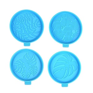May include: Four blue silicone molds with different tropical leaf designs. The molds are numbered 8790, 8791, 8792, and 8793.