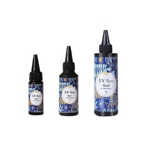 May include: Three bottles of UV resin, labeled "UV Resin Hard", with a blue and gold floral design. The bottles are different sizes.