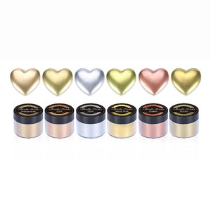 May include: Six small jars of metallic powder in the colors antique gold, gold, silver, merrick gold, copper, and bronze. Each jar has a black lid and a white label with the words "Metallic Powder" and the color name.