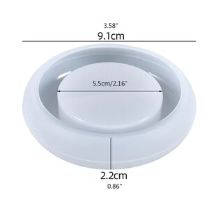 May include: A white, circular mold with a raised center and a surrounding rim. The mold measures 3.58 inches (9.1 cm) in diameter, with the center section measuring 2.16 inches (5.5 cm) across. The height is 0.86 inches (2.2 cm).