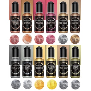 May include: Set of 12 alcohol ink bottles with a variety of colors, including reddish brown, bronze, wine red, ruby red, red gold, coffee, dark grey, silver grey, golden, alluvial gold, deep gold, and green gold. Each bottle has a black cap and a small sample of the color underneath.