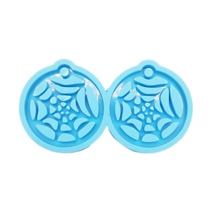 May include: Two light blue silicone molds for making resin earrings. Each mold is round and features a web-like design.